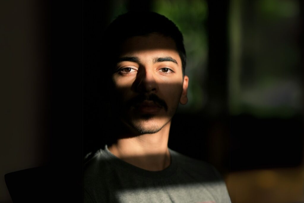 man in the dark observing something or someone symbolising desire and arrousal