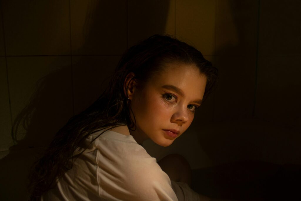 Young woman with sad eyes from the side symbolising trust and connection issues